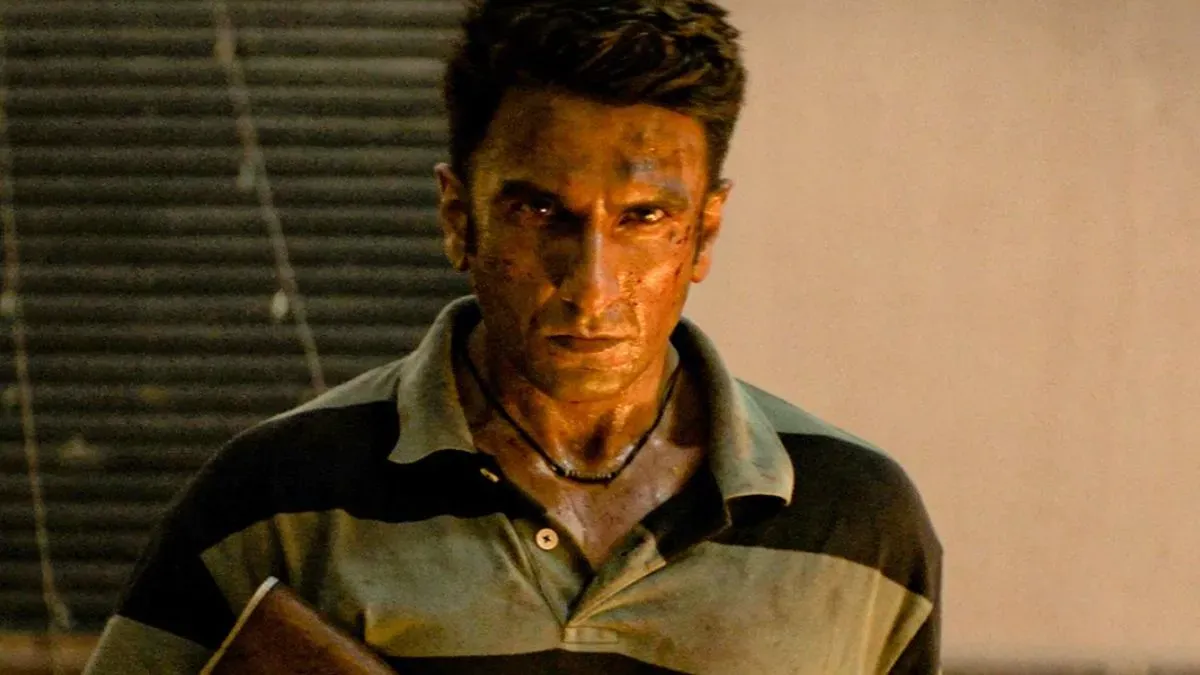 Ranveer Singh in Dhurandhar 2 fiercely stares, celebrating box office success.