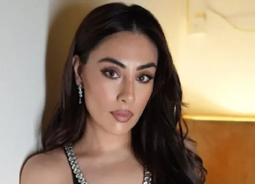 Tina Thadani looking ecstatic as she stands next to Rihanna, who is smiling.