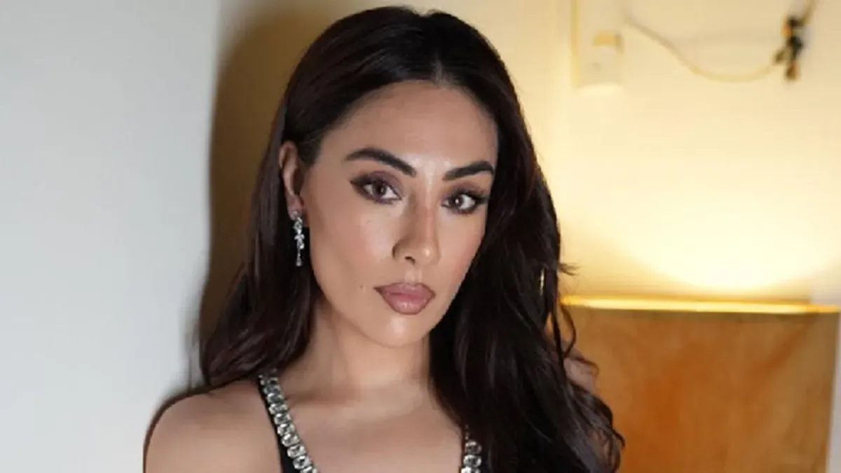 Tina Thadani looking ecstatic as she stands next to Rihanna, who is smiling.