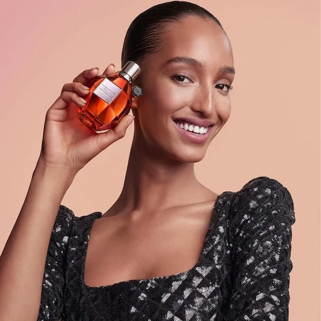A colorful display of perfume bottles on a shelf.