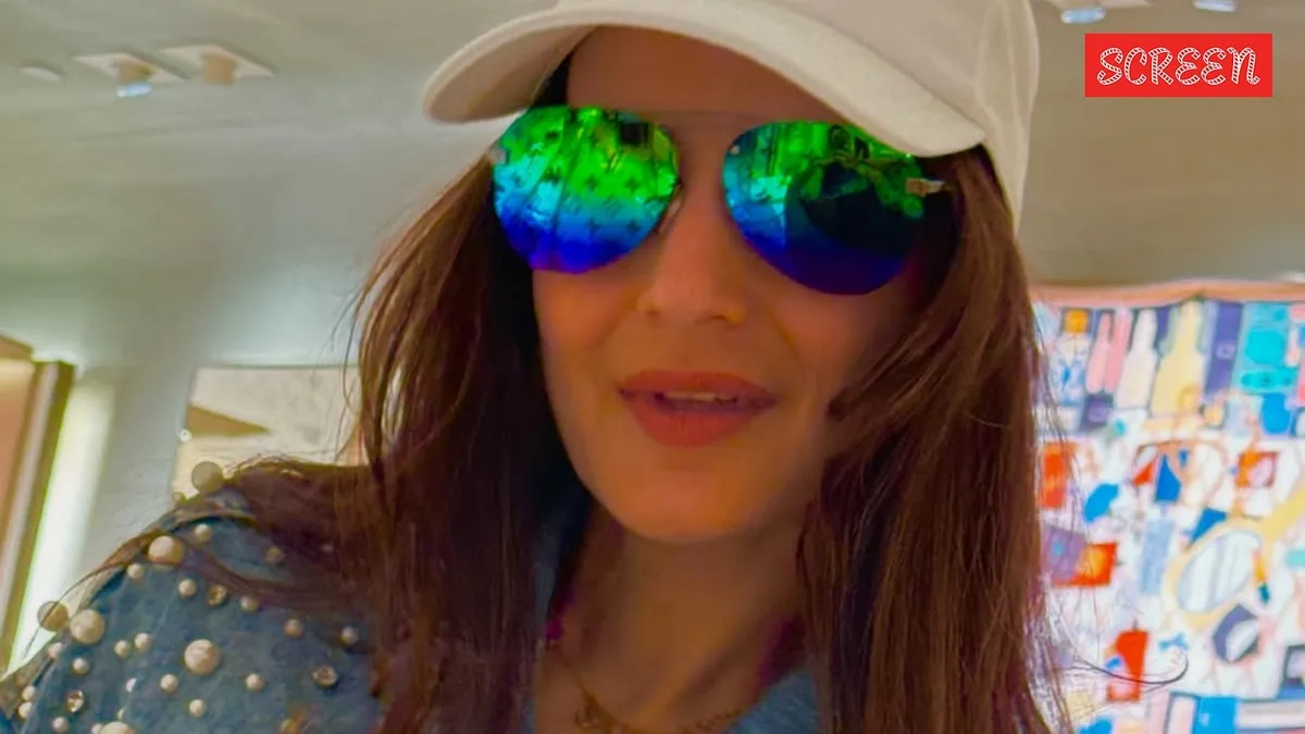 Ameesha Patel smiling, with a subtle old photograph filter, hinting at a past connection.