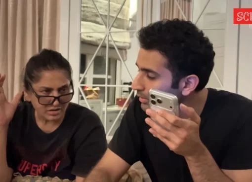 Archana Puran Singh smiling, with a hint of her son in the background.