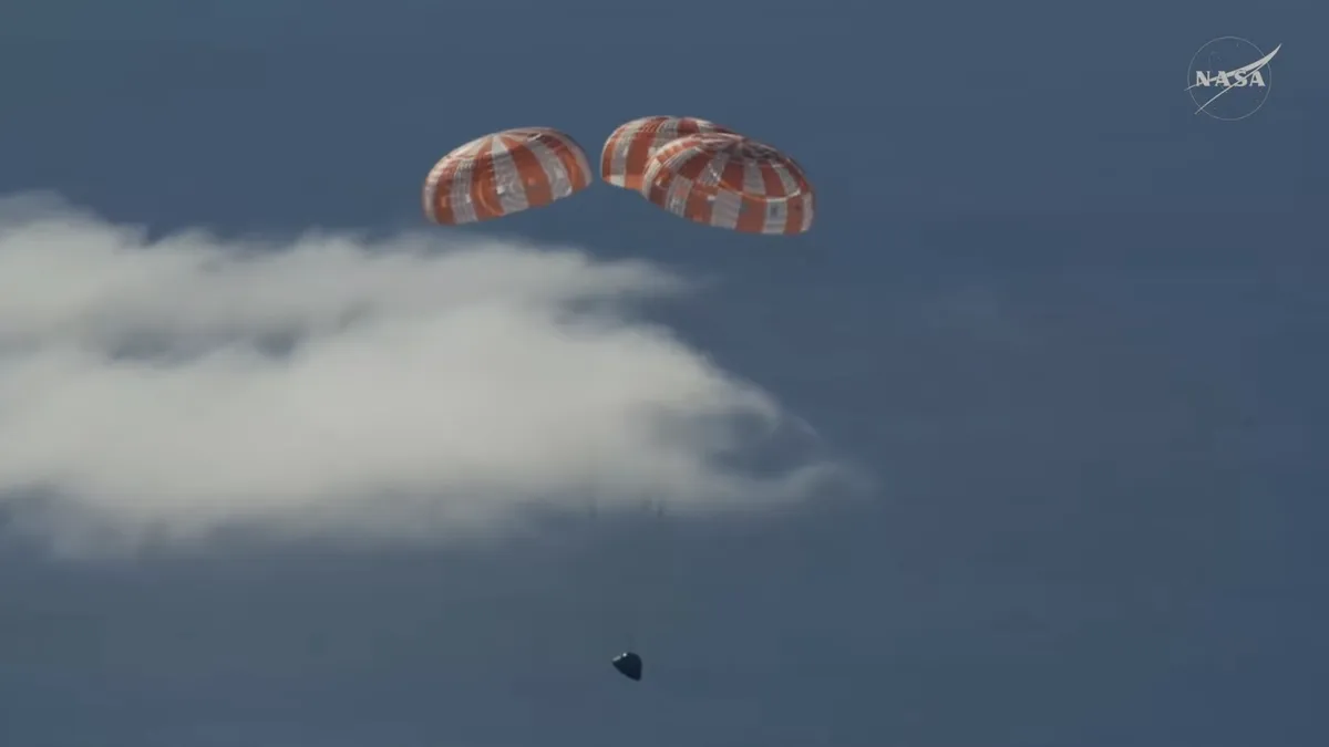 Astronauts splashing down in the ocean.