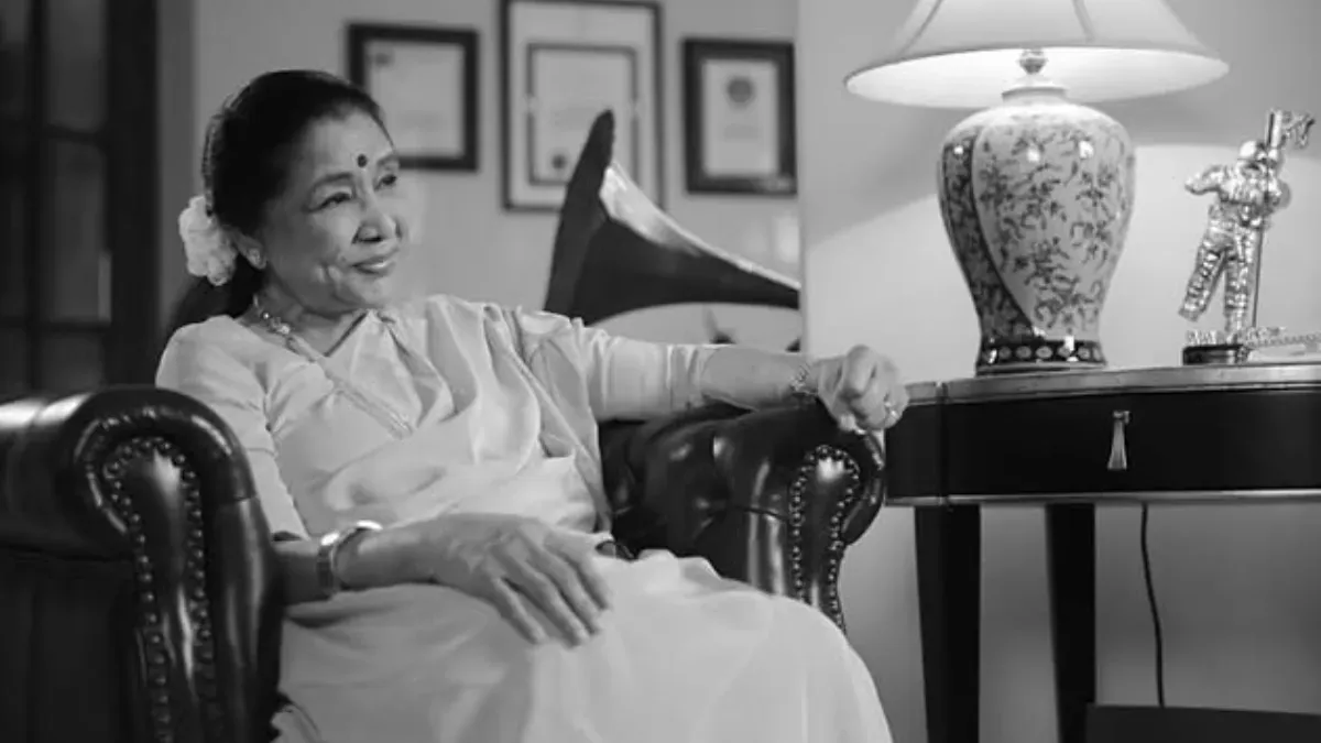 Asha Bhosle smiling in a photograph.