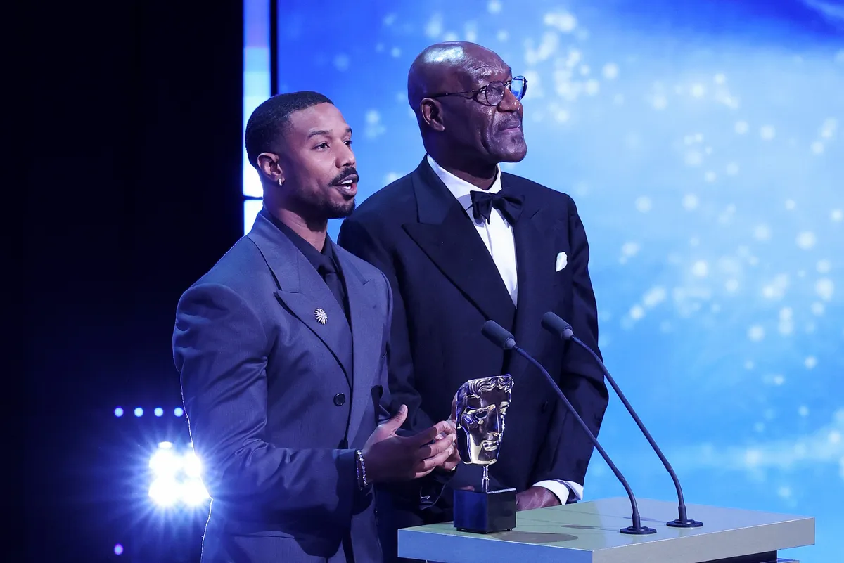 The BAFTA stage with the iconic gold mask award visible against a dark background.