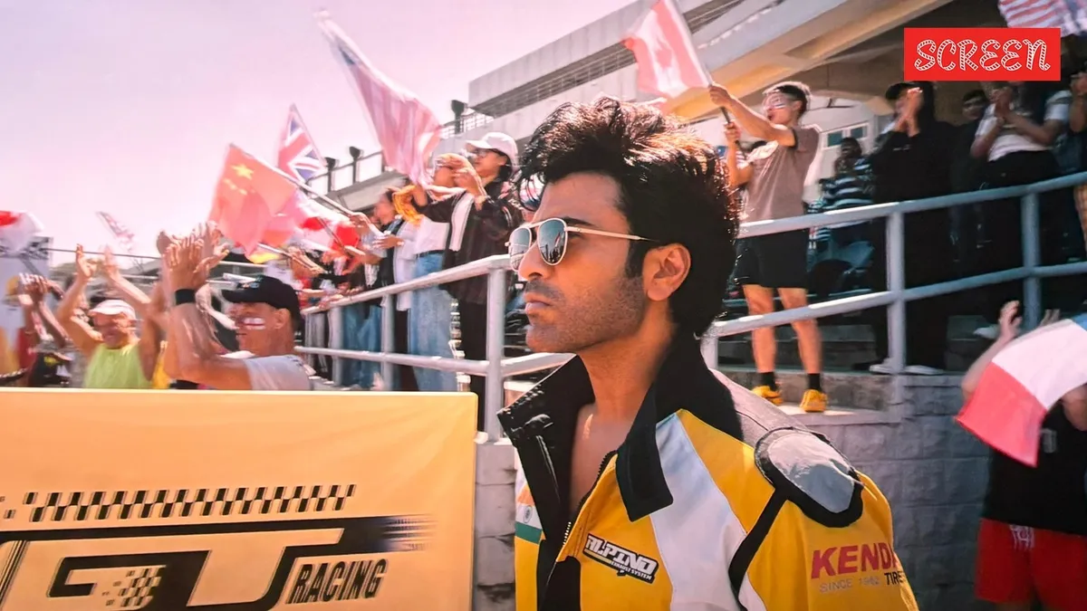 Sharwanand in action on a motocross bike during a thrilling race scene.