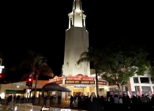 Billie Eilish performing on stage with blue lighting.