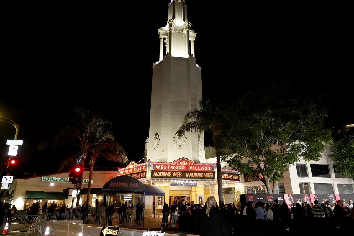 Billie Eilish performing on stage with blue lighting.