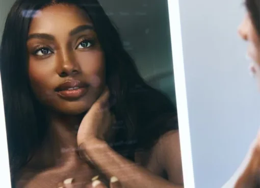 A person looking into a sleek, modern smart mirror.