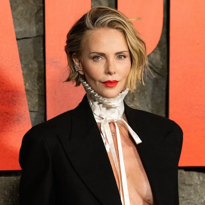 Charlize Theron smiling while talking about her daughter August