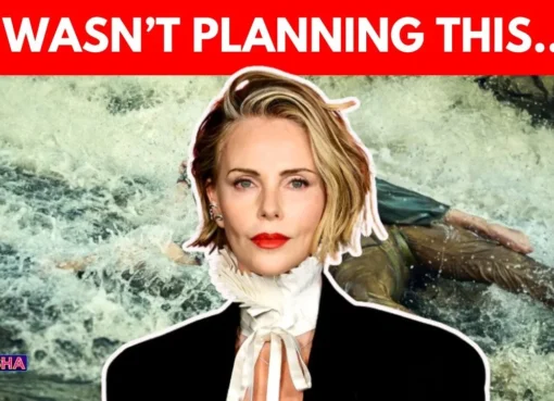 Charlize Theron smiling on a red carpet.