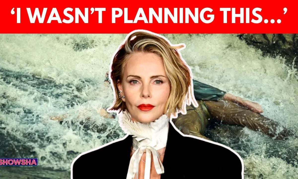 Charlize Theron smiling on a red carpet.