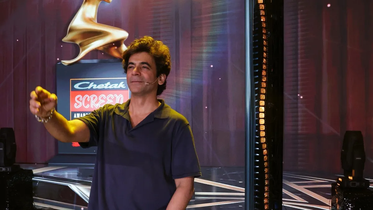 Golden Chetak Screen Awards trophy illuminated on a grand stage.