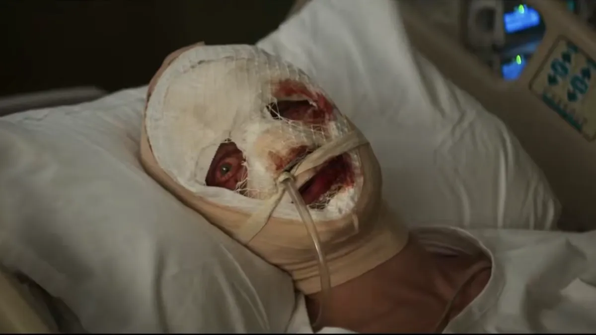 A still from the 'Clayface' trailer showing a close-up of Matt Hagen's face in mid-transformation, looking distorted and grotesque with clay-like textures.