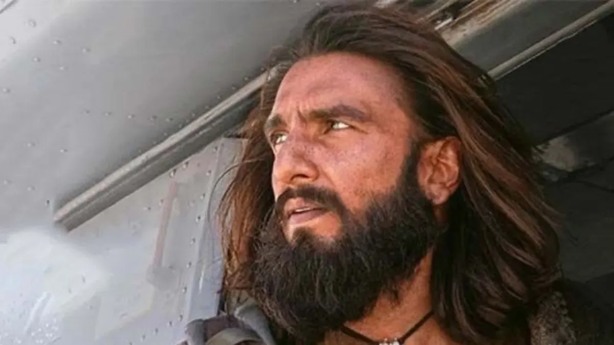 A vibrant movie poster for Dhurandhar: The Revenge, showing Ranveer Singh in action with bold, dramatic colors.