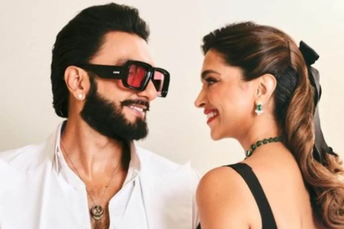 Ranveer Singh smiling and looking excited on a quiz show.