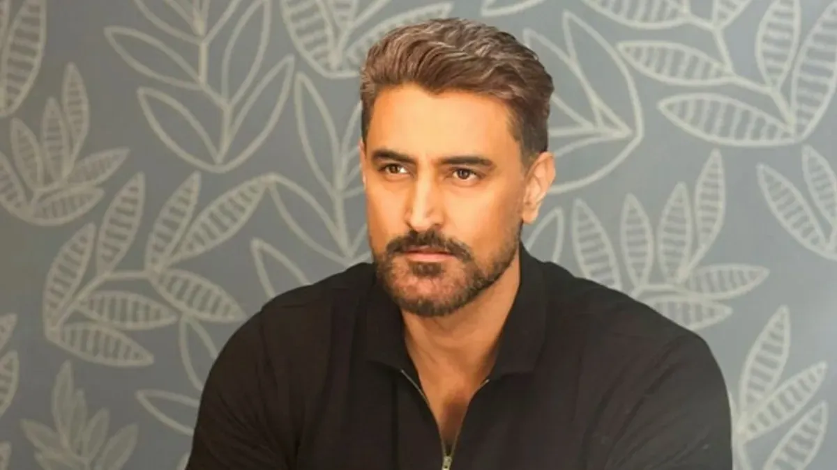 Kunal Kapoor smiling, possibly at a promotional event.