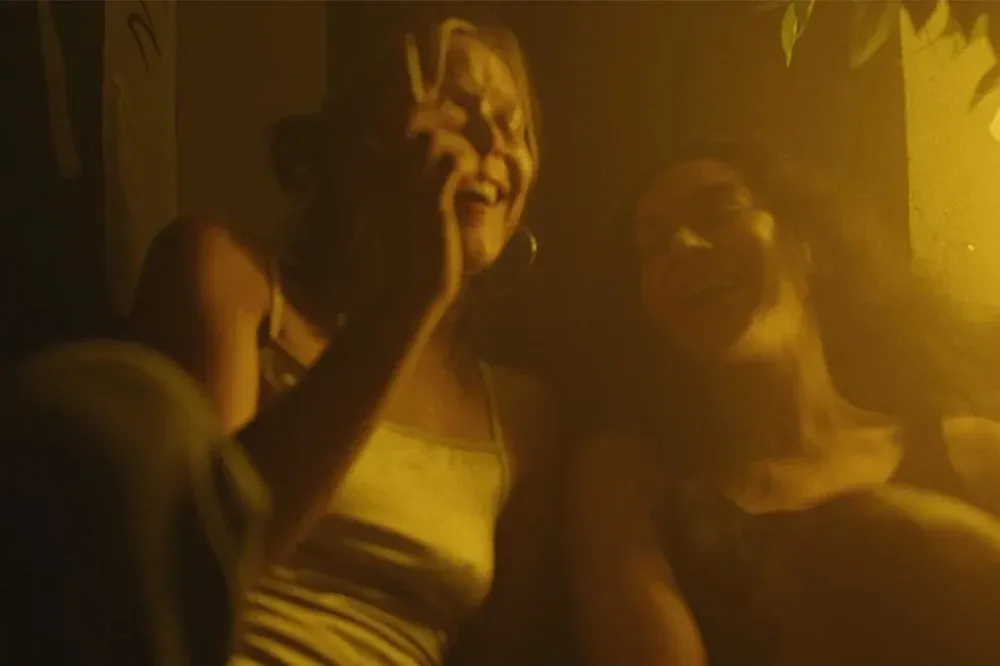 A dramatic still from a movie, showing a couple in an intense, emotional moment with subtle hints of fiery, volcanic colors in the background.