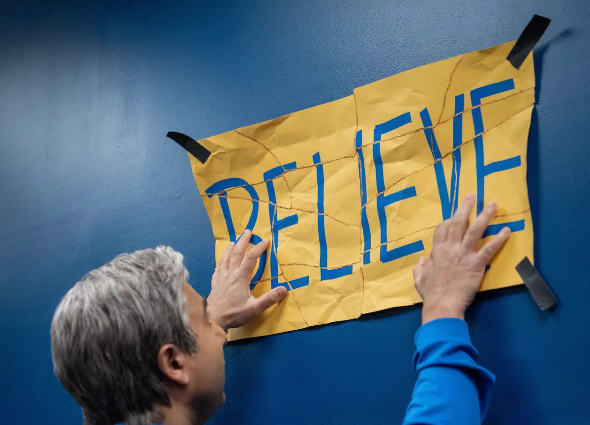 Ted Lasso cast celebrating on a football pitch.