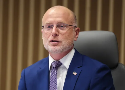 A broadcast tower against a cloudy sky.