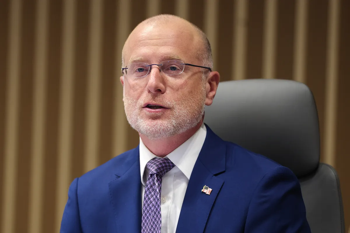 A broadcast tower against a cloudy sky.