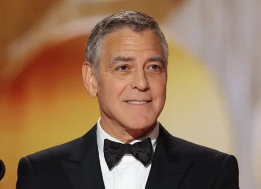 George Clooney in a suit, looking thoughtful and composed.