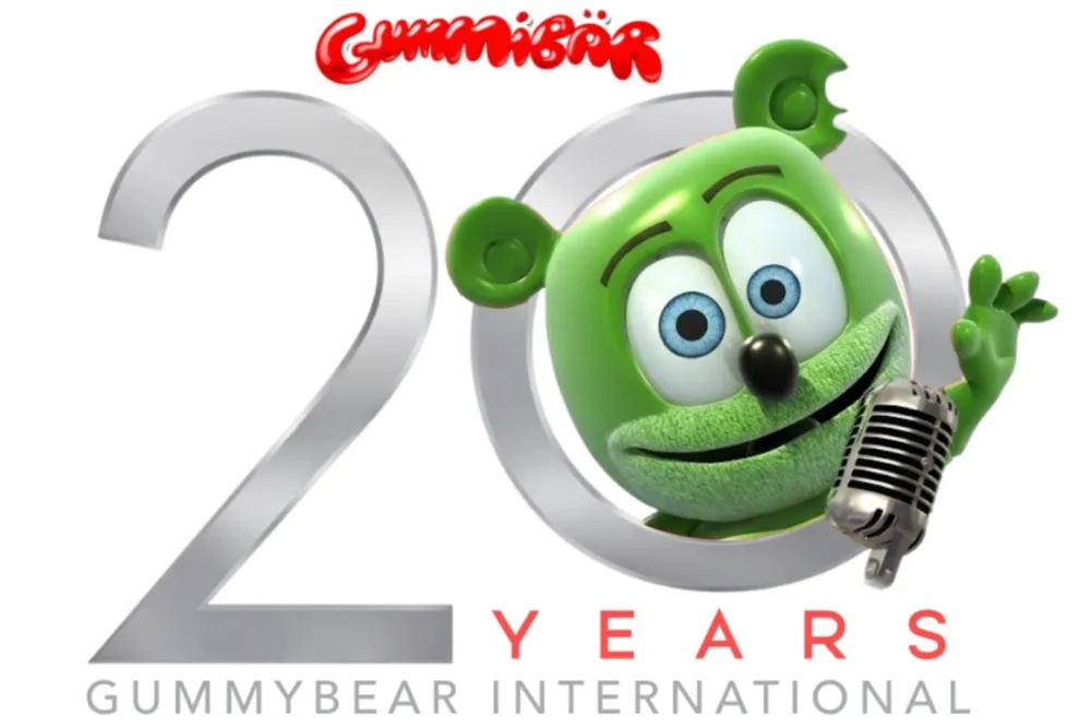 A vibrant green cartoon gummy bear smiling and dancing.