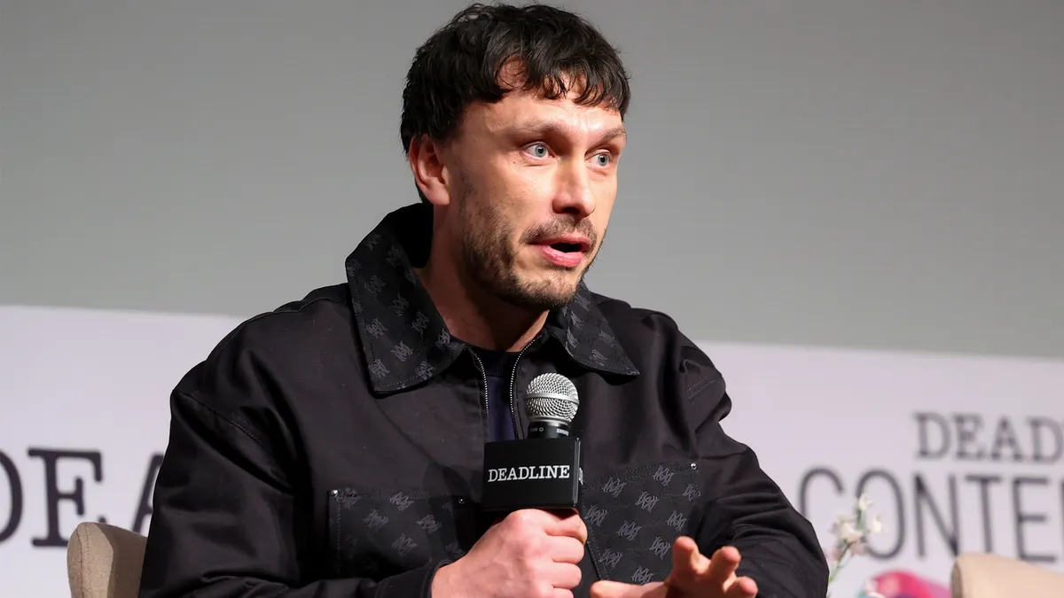 Richard Gadd smiling and talking at an event.