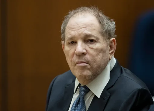 Harvey Weinstein in a serious courtroom setting, wearing a suit.