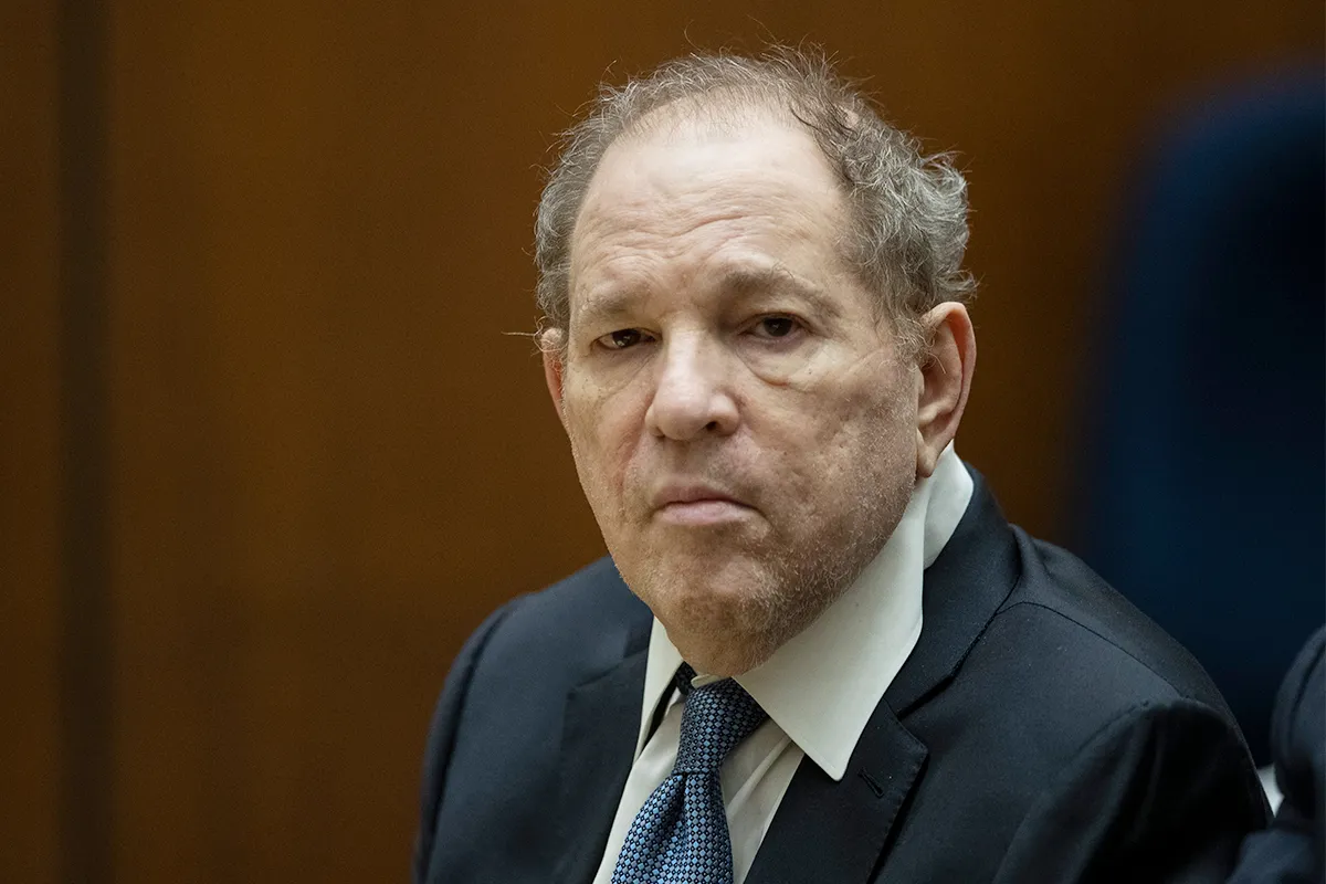 Harvey Weinstein in a serious courtroom setting, wearing a suit.