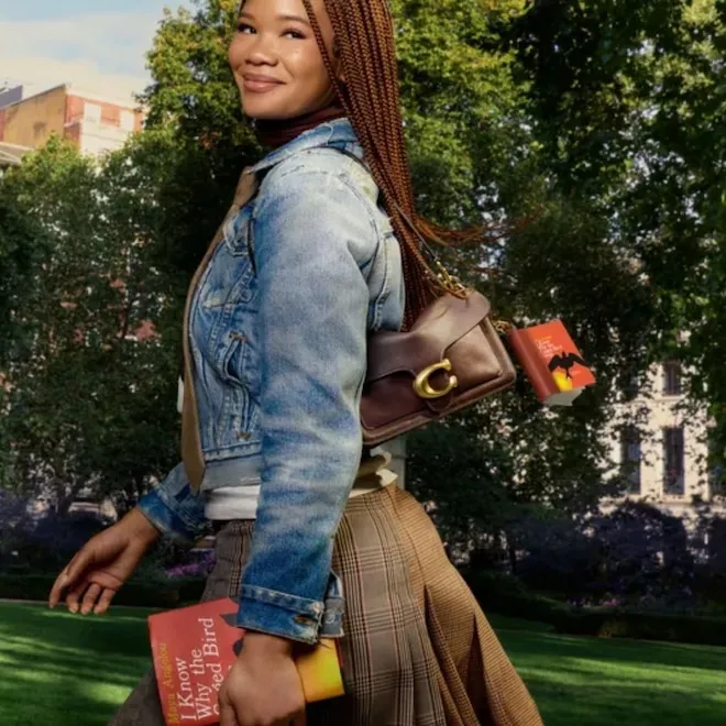 A close up of a vintage-style Coach bag with signature canvas print