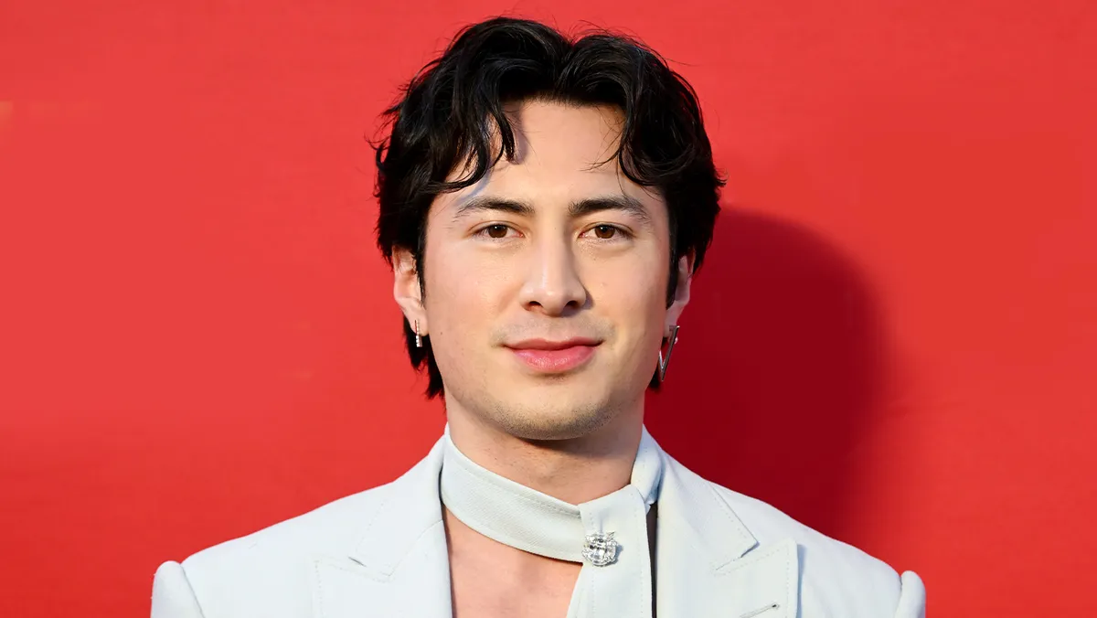 Hudson Williams looking dramatic in a dark setting