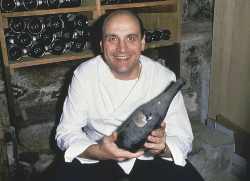 A picture of a renowned French chef in a kitchen.