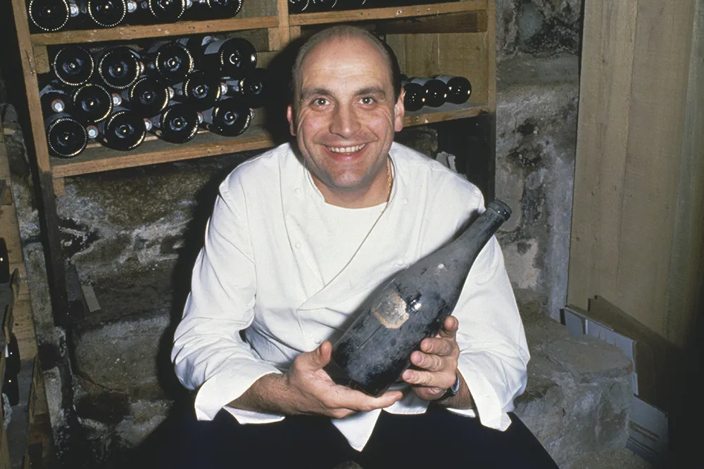 A picture of a renowned French chef in a kitchen.