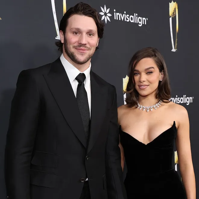 Hailee Steinfeld and Josh Allen smiling, holding their newborn baby girl.