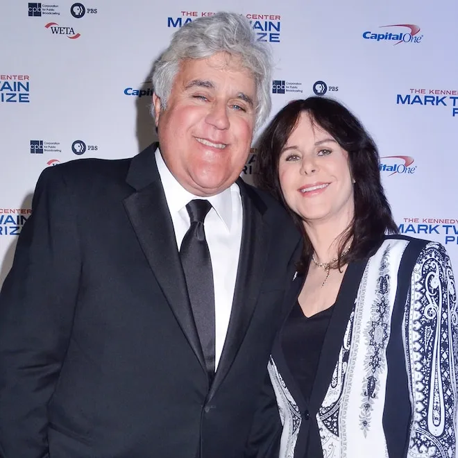 Jay Leno and Mavis Leno smiling warmly together, looking happy and content.
