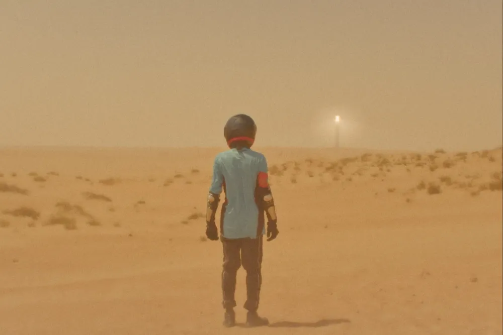 Still from the movie 'Heat' showing intense heat or a person experiencing extreme weather.