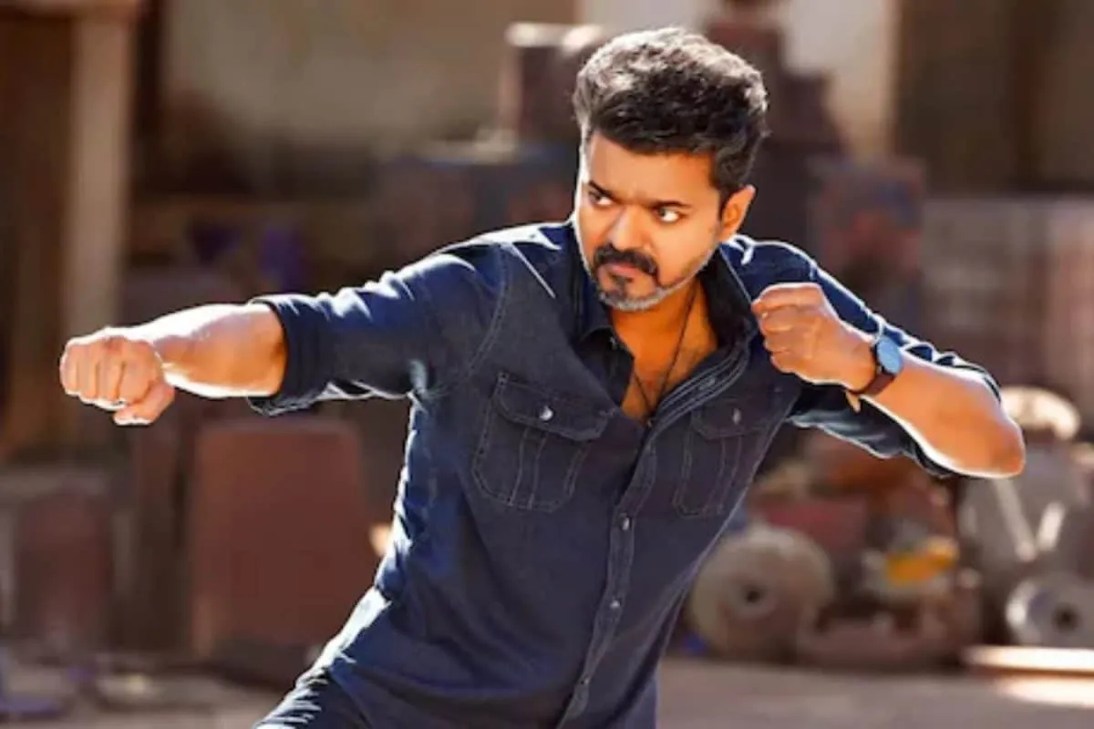 Thalapathy Vijay looking intense on a movie set with professional lighting equipment.