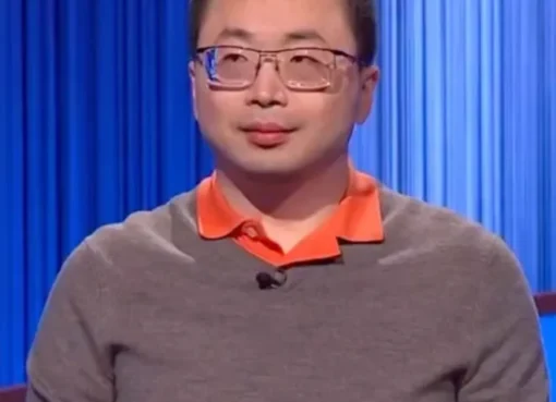 Jamie Ding standing at a Jeopardy podium looking focused