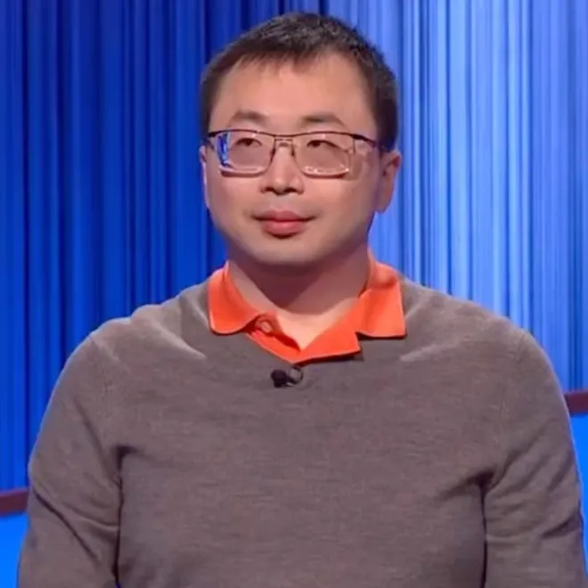 Jamie Ding standing at a Jeopardy podium looking focused