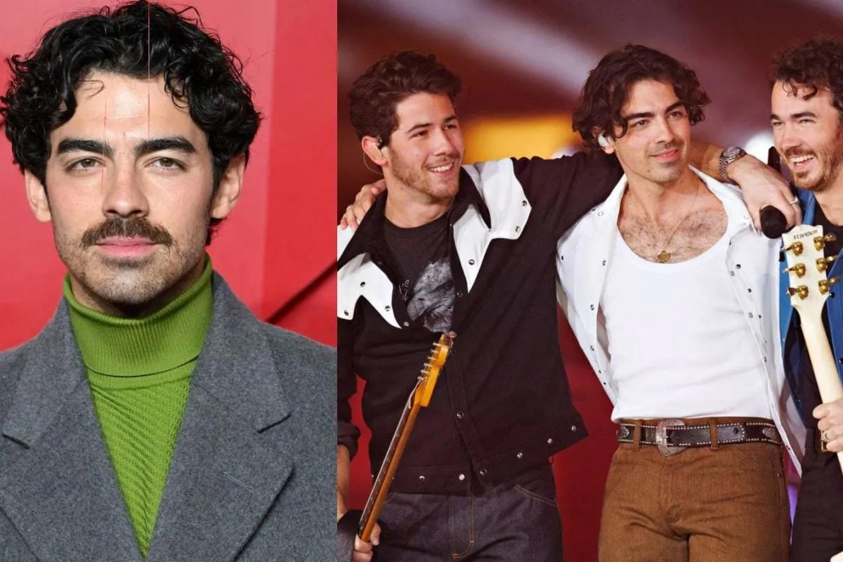 Joe Jonas smiling on stage with a guitar, perhaps looking a bit thoughtful.