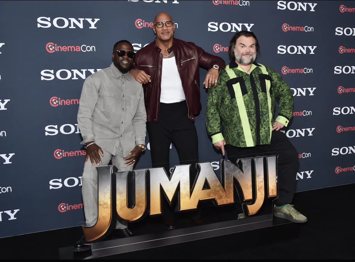 Dwayne Johnson, Kevin Hart, and Jack Black in a Jumanji movie scene.