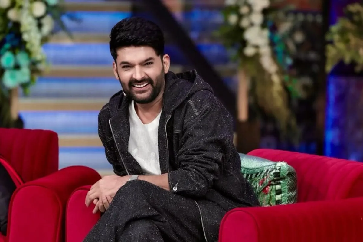 Kapil Sharma speaking on a stage.