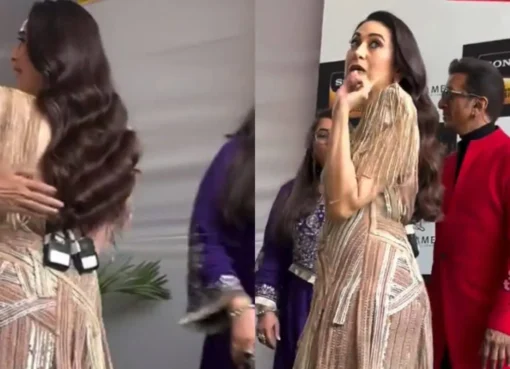 Karisma Kapoor looking elegant while talking to paparazzi on a film set.