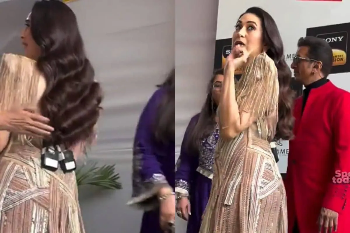 Karisma Kapoor looking elegant while talking to paparazzi on a film set.