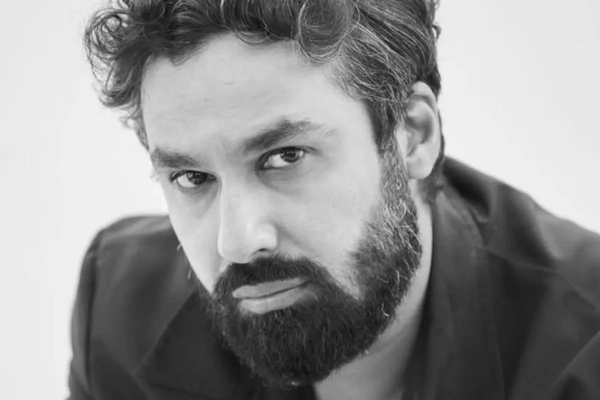 Kunal Nayyar smiling during an interview about his new app.