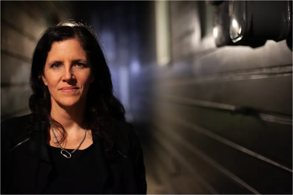 Filmmaker Laura Poitras speaking at a festival event.