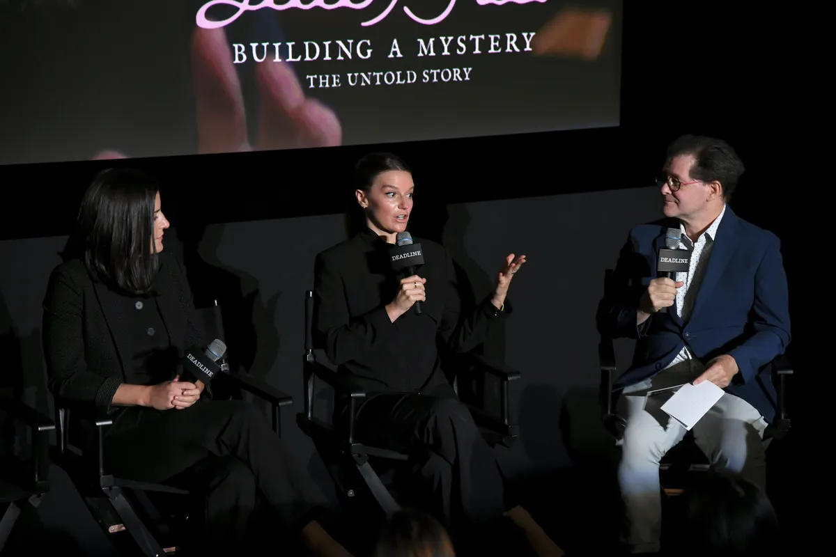 A group of female musicians performing on stage at an outdoor festival.