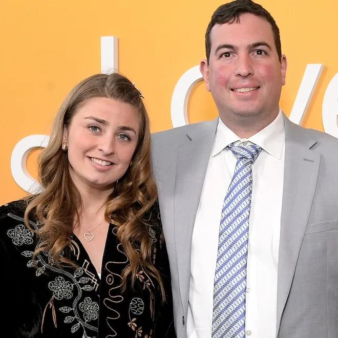 Abbey Romeo and David Isaacman standing together and smiling.