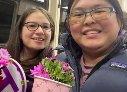 Pari Kim and Tina Zhu Xi Caruso smiling together from Love on the Spectrum